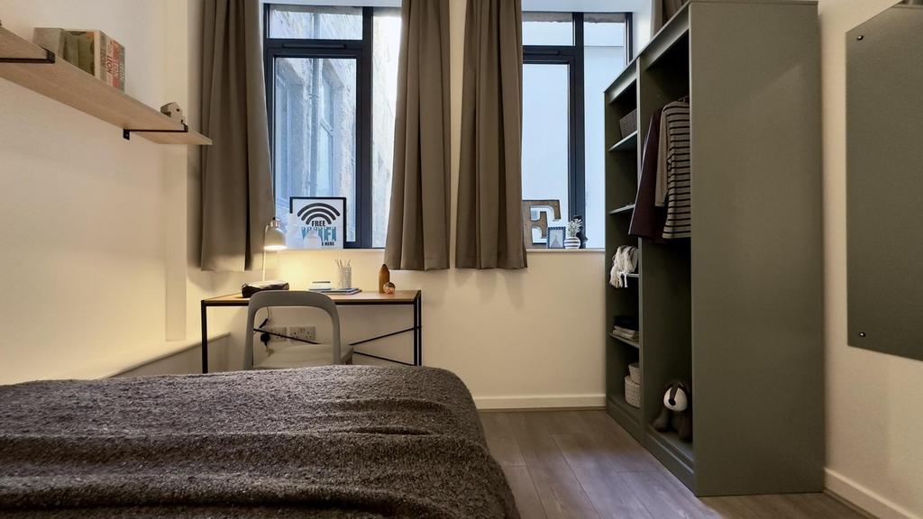 A stylish and well-lit double bedroom featuring...