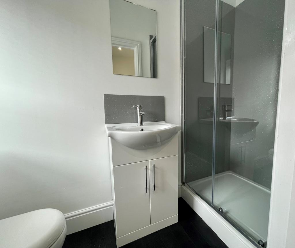 A clean and modern bathroom with minimalist fix...