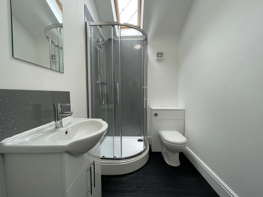 A modern and tidy bathroom featuring a walk-in ...