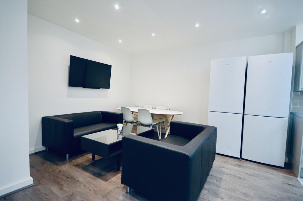 A modern, well-lit living room featuring two bl...