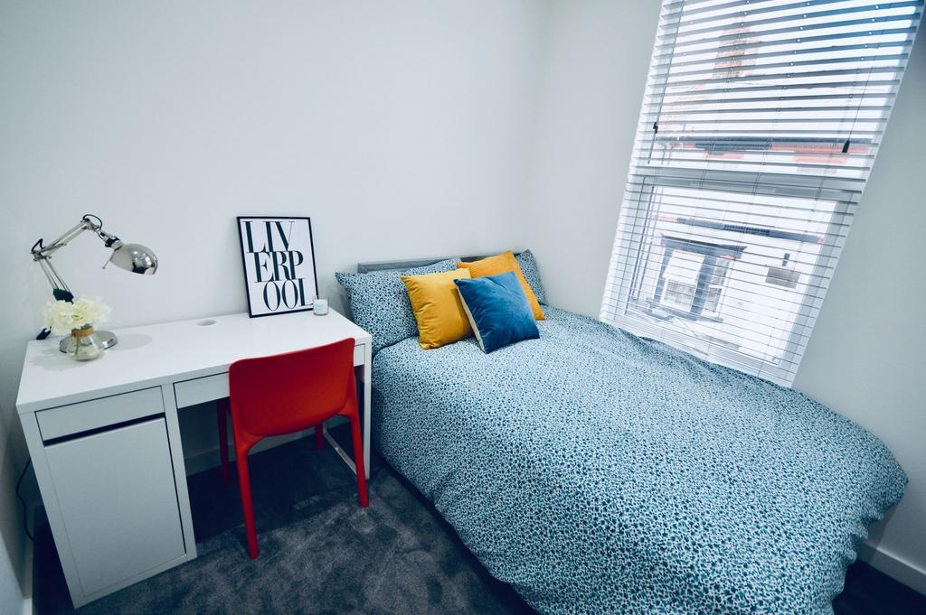 Bright and stylish bedroom featuring a large be...