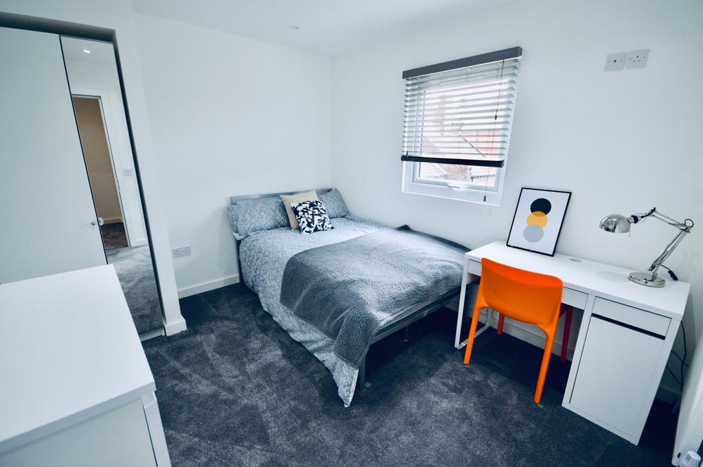 Bright and modern double bedroom featuring a co...