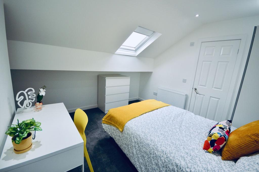 Bright and inviting bedroom with a skylight win...