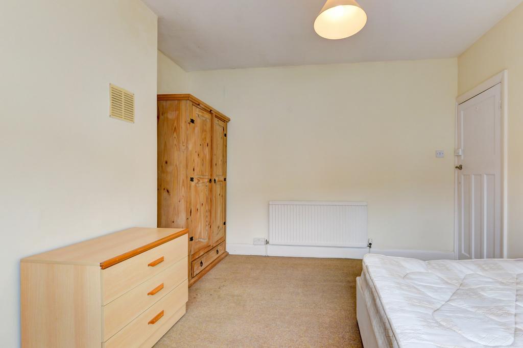 A bright and inviting double bedroom featuring ...