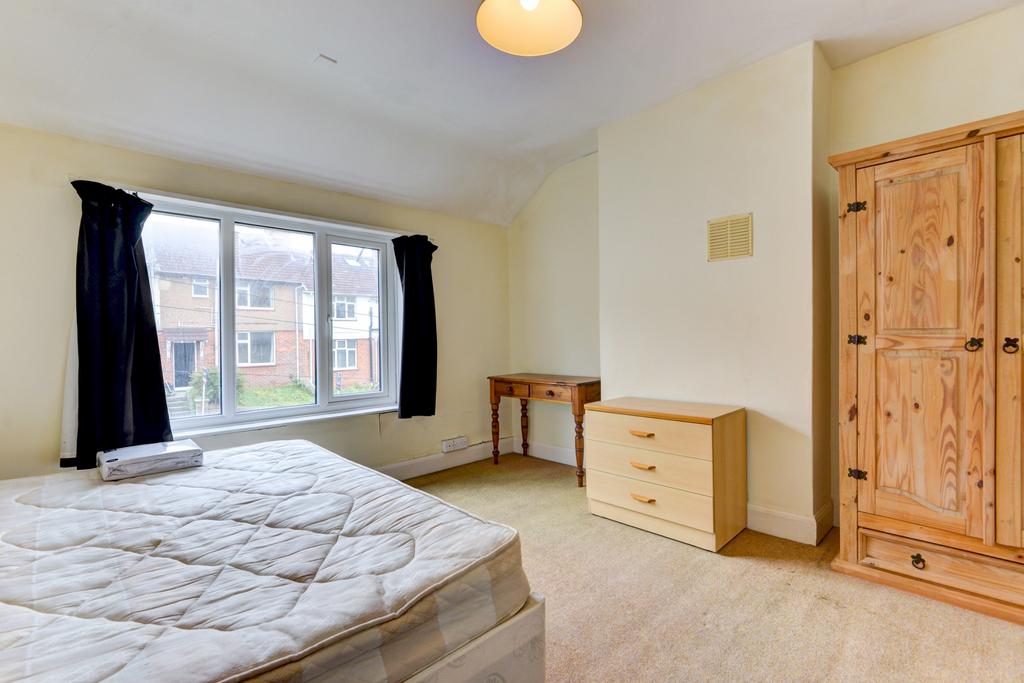 A bright, tidy bedroom featuring a double bed, ...