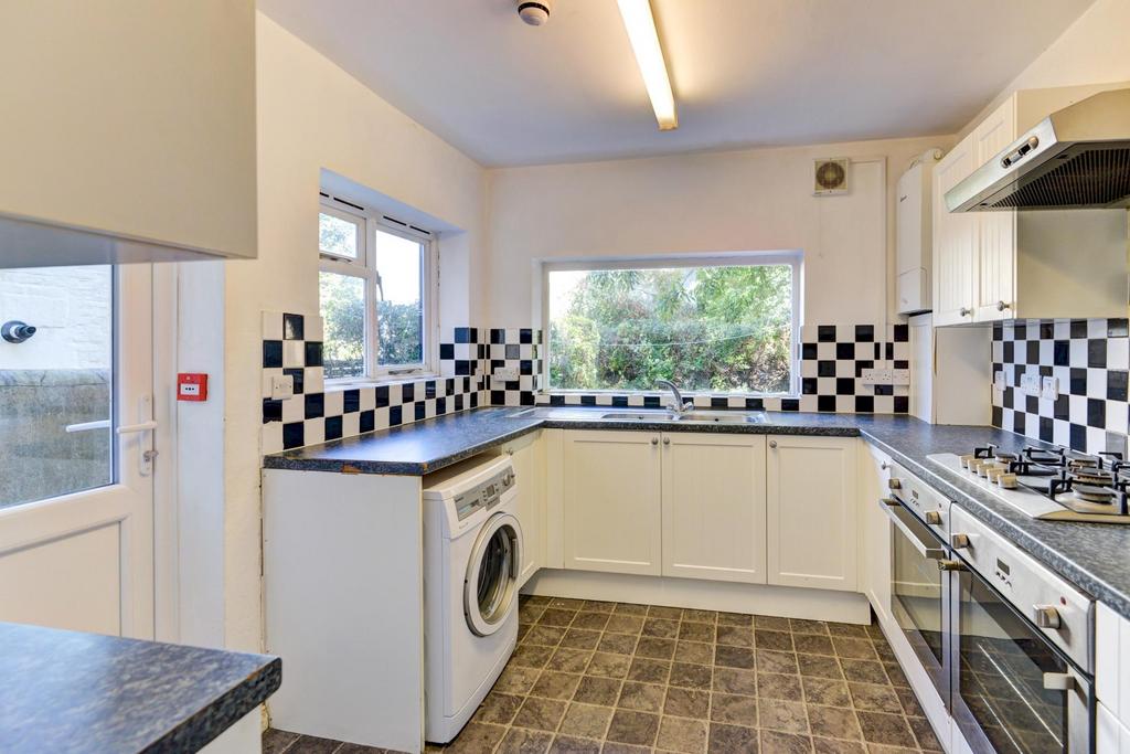 A bright and functional kitchen with ample coun...