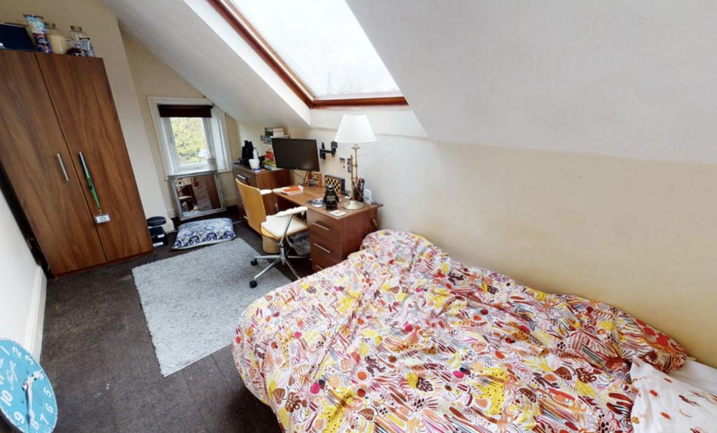 A cozy bedroom featuring a spacious bed with co...