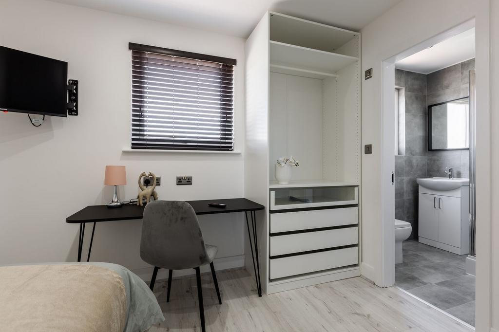 Bright and modern bathroom with gray tiled wall...