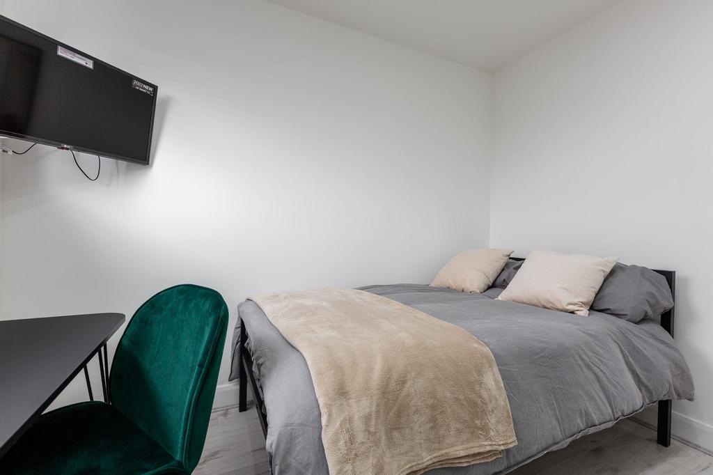 A cozy bedroom featuring a comfortable double b...