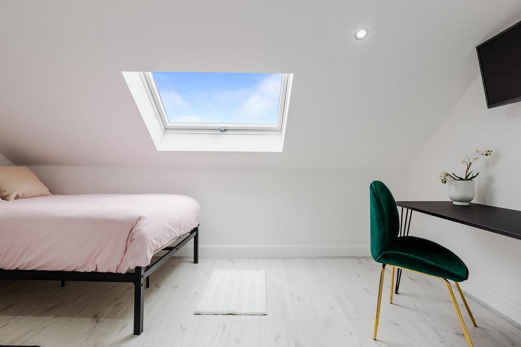 Bright and airy single bedroom with a skylight ...