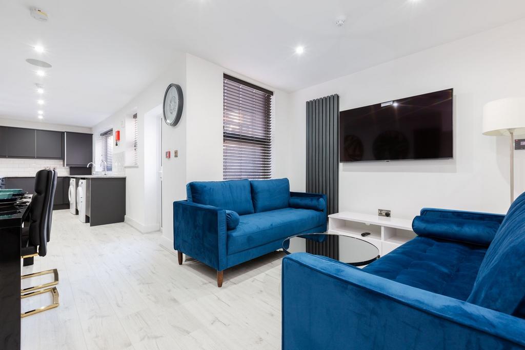 Modern and spacious living room featuring vibra...