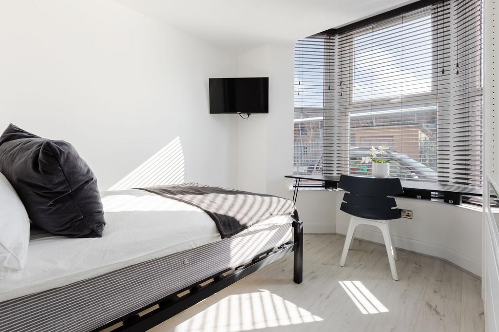 Bright and inviting single bedroom featuring a ...