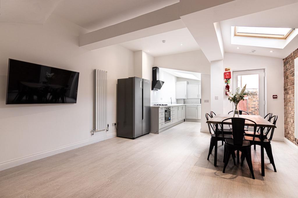 Bright, modern open-plan living and kitchen are...