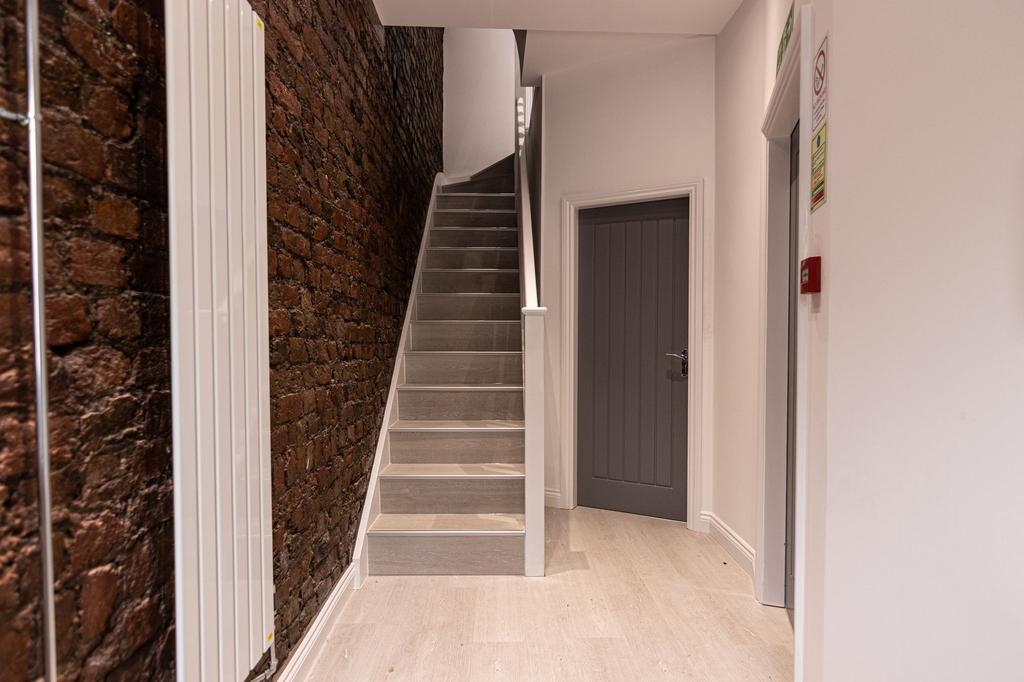 Well-finished interior stairwell with exposed b...