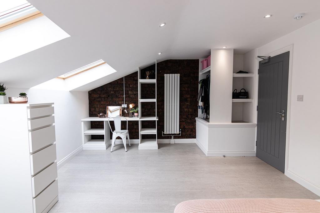 Bright, contemporary loft bedroom with skylight...