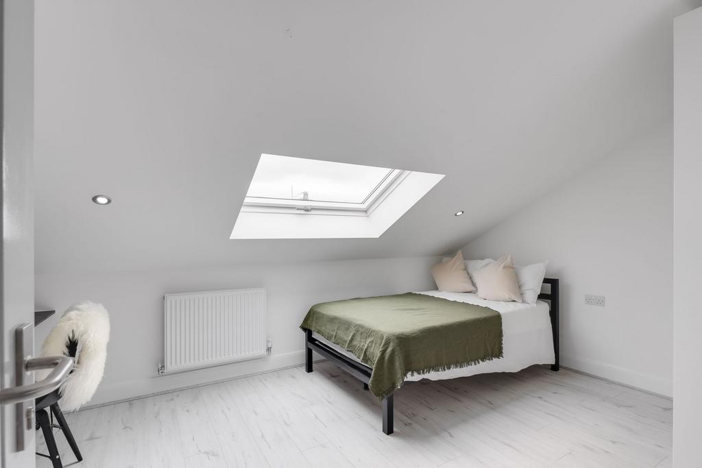A bright and modern double bedroom with a large...