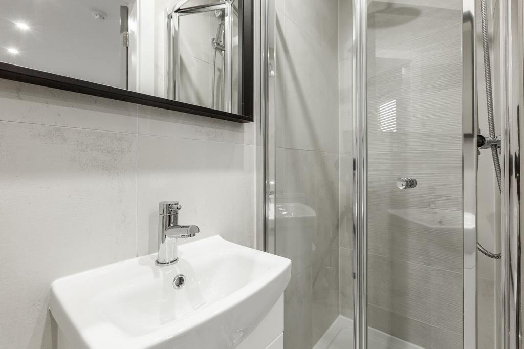 Modern bathroom featuring a compact sink, a spa...