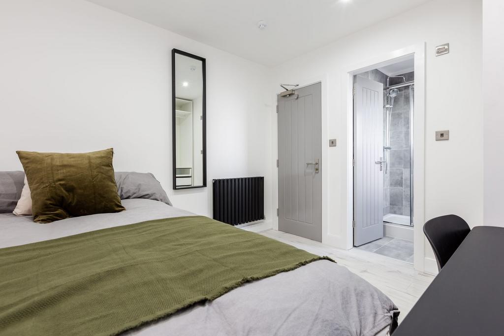 A modern, tidy bedroom featuring a comfortable ...