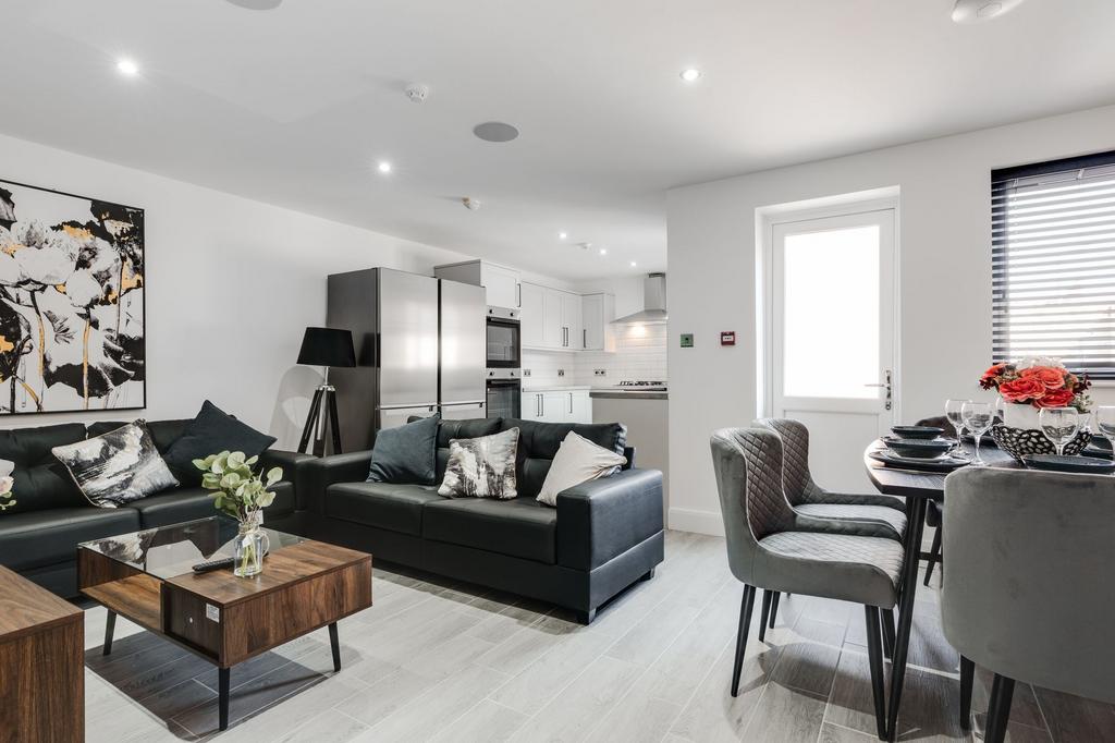 Modern, spacious living room featuring comforta...