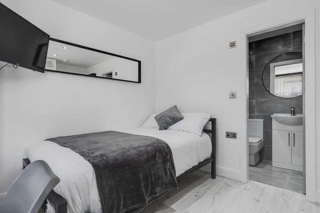 A compact and clean single toilet room with mod...