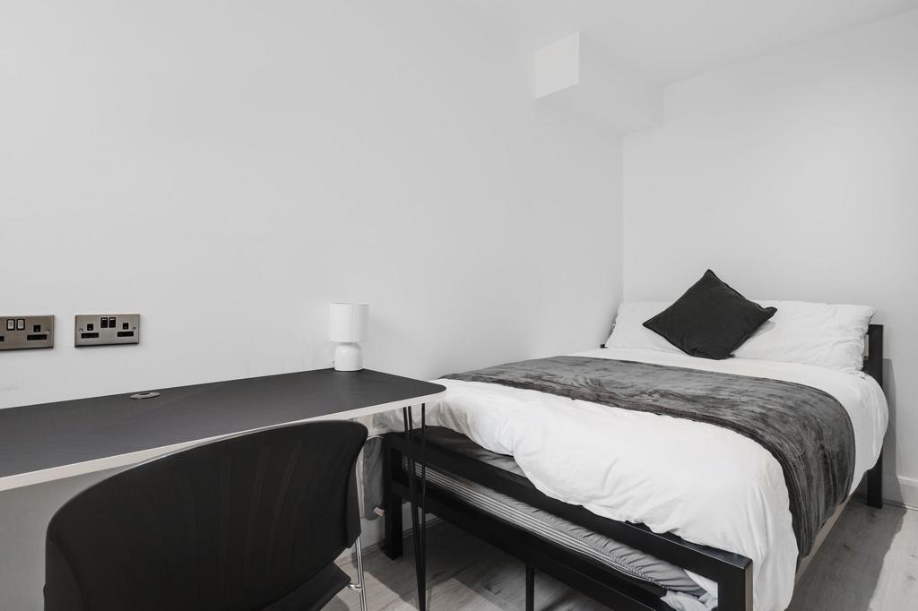 A modern, immaculate bedroom featuring a neatly...