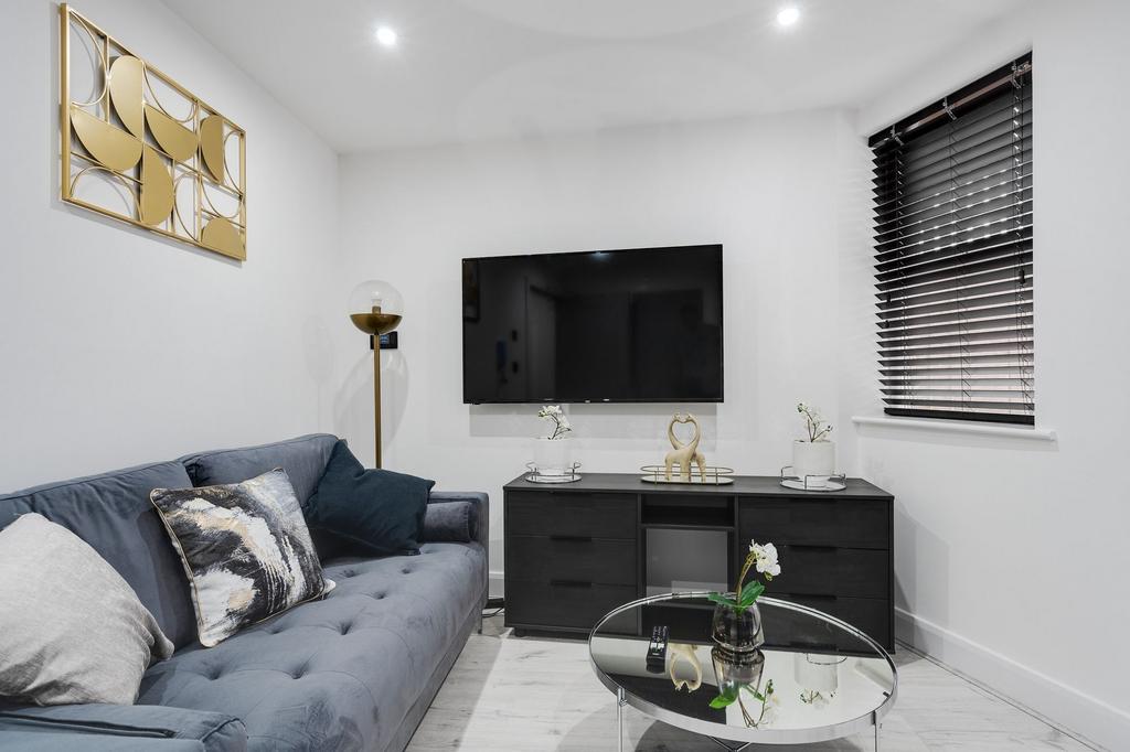 Modern living room featuring a comfortable grey...