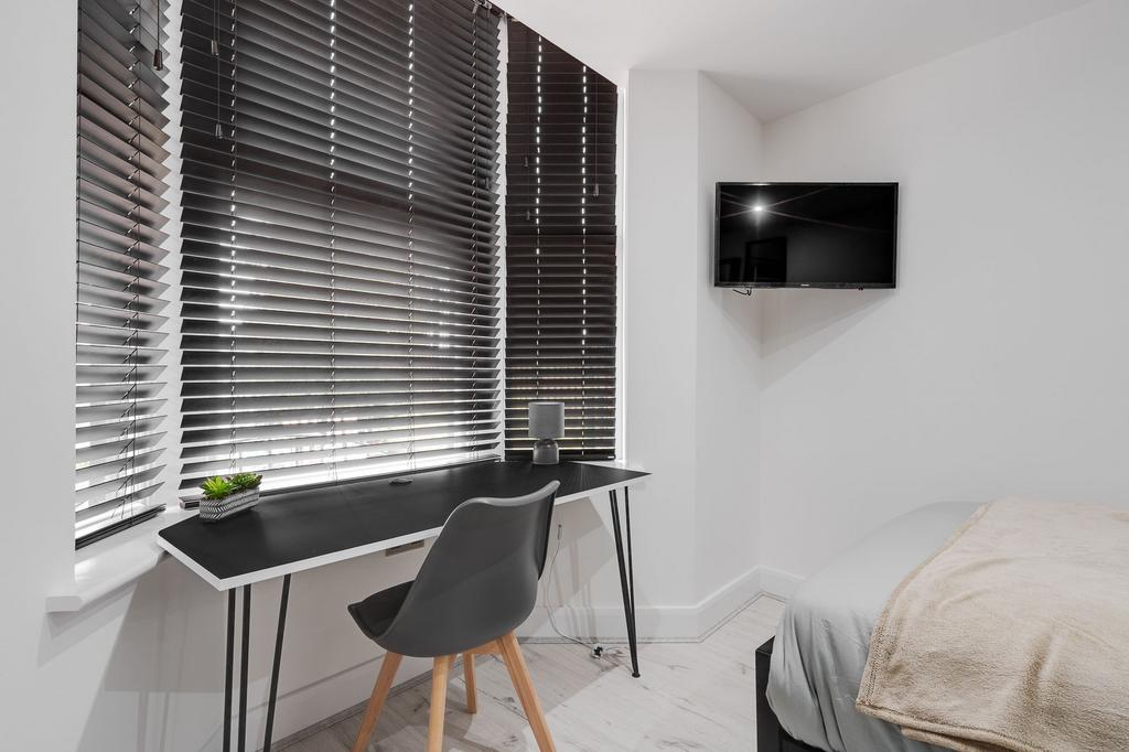 A bright and modern bedroom featuring a large w...