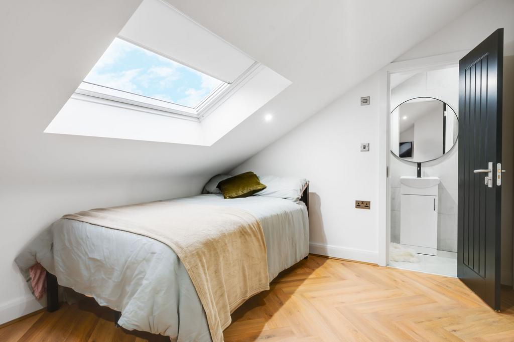 Bright and welcoming bedroom with a skylight wi...