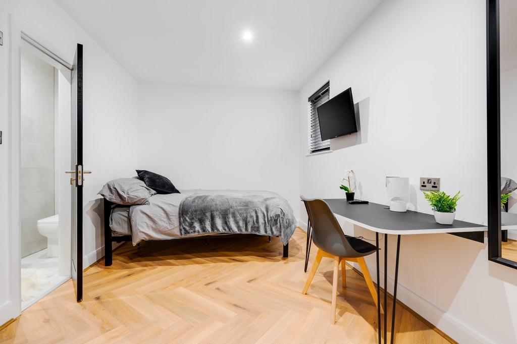 Modern and tidy bedroom featuring a comfortable...