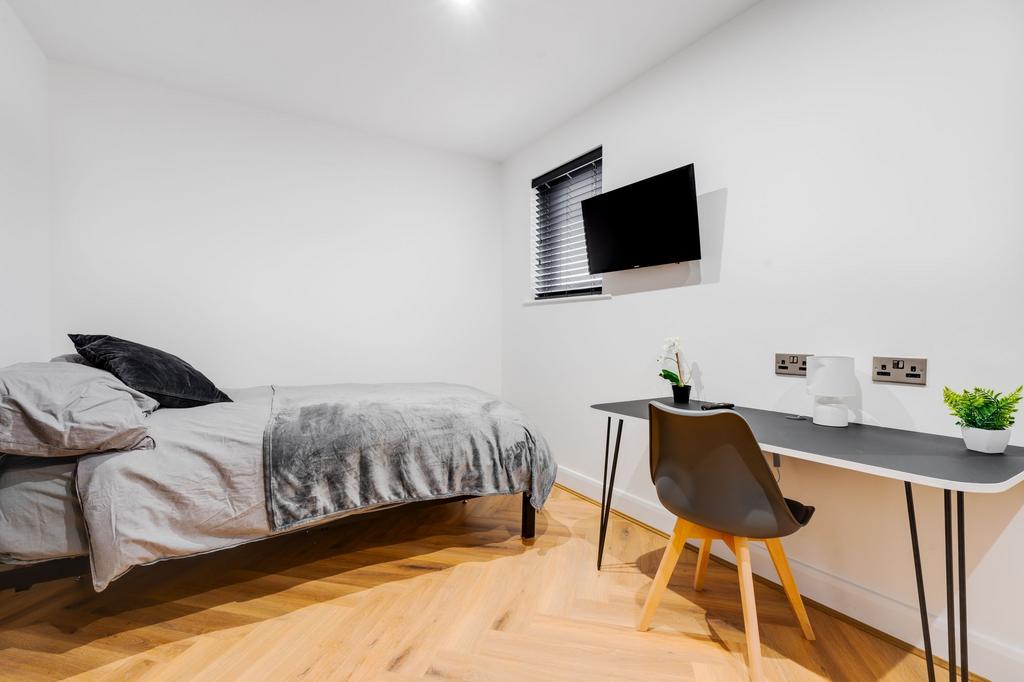 Bright and modern double bedroom featuring a la...