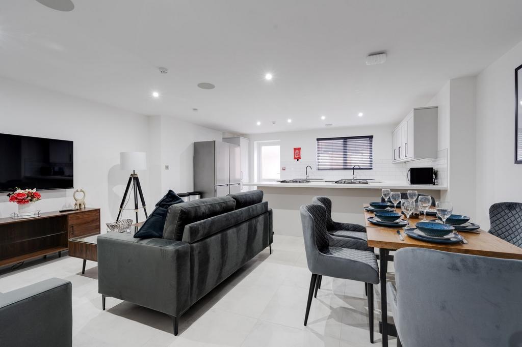 Spacious and modern living room with ample natu...