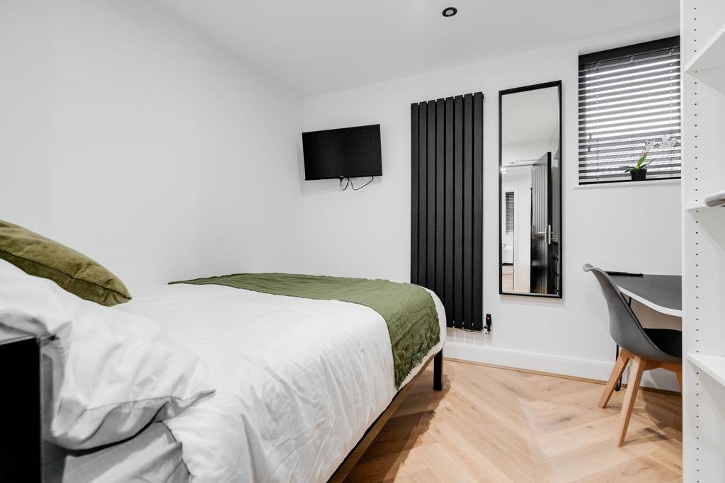 A modern, well-maintained bedroom featuring a c...