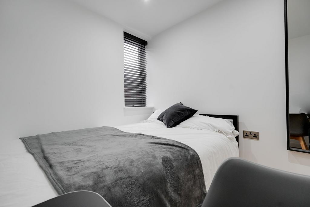 A modern, well-maintained bedroom with a neatly...