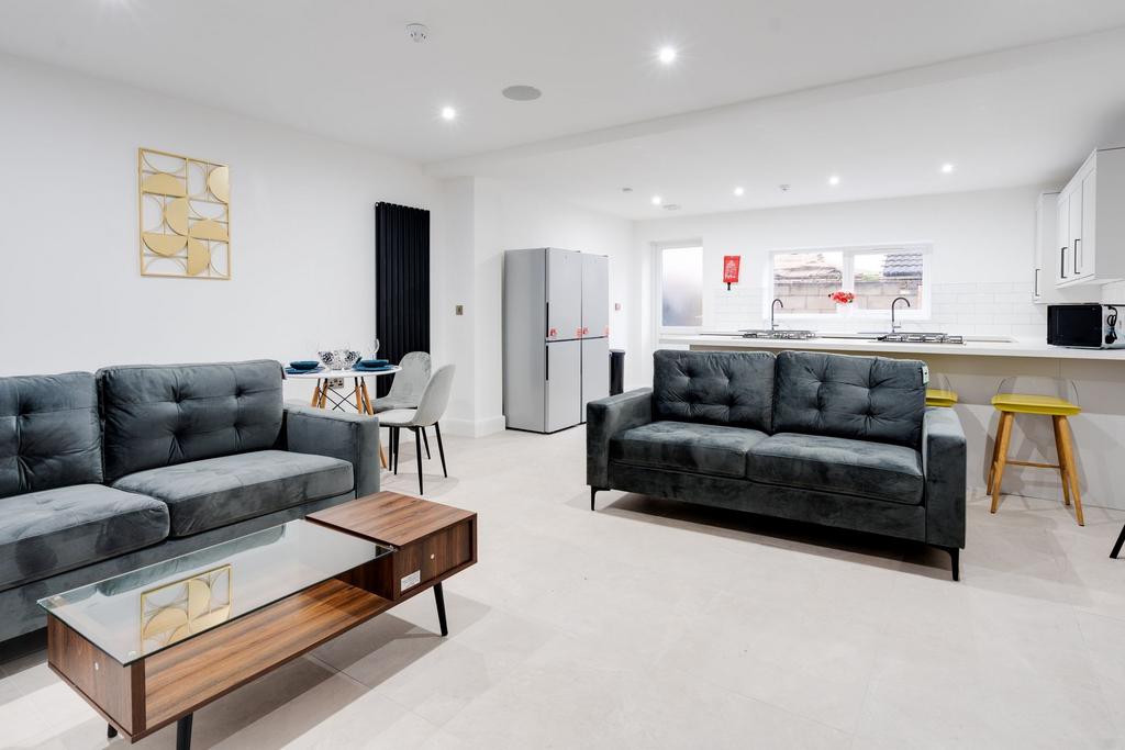 A modern and spacious living area featuring two...