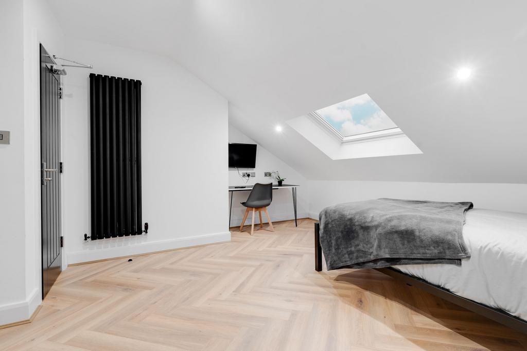 Bright and spacious master bedroom with a large...