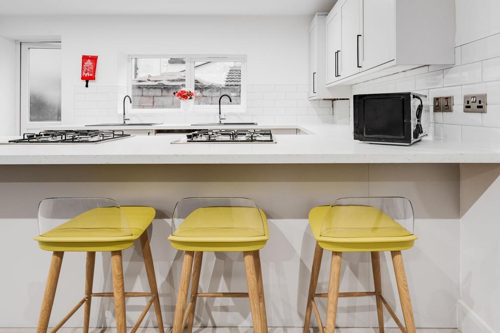 Modern, bright kitchen with clean white units, ...