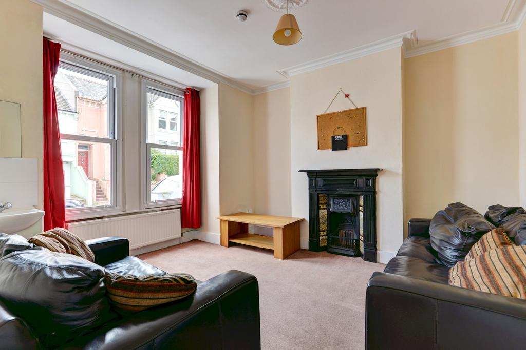 A spacious and well-lit living room featuring l...