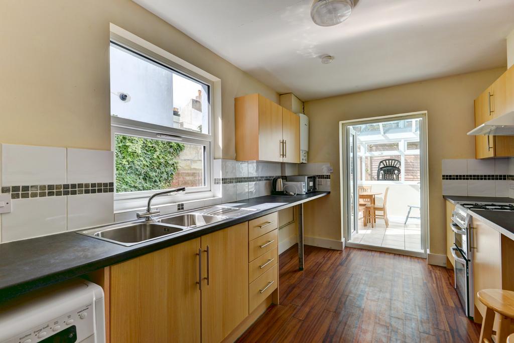 A bright, well-maintained kitchen with wooden c...