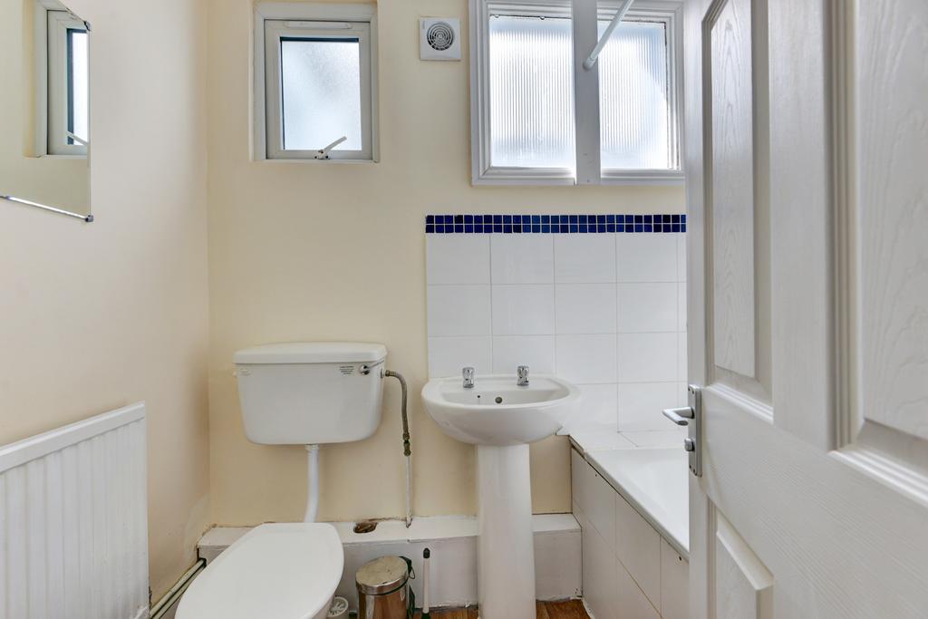 A well-maintained bathroom featuring a bathtub,...