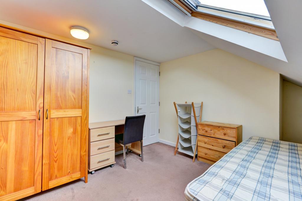 Bright and cozy bedroom with a comfortable bed,...