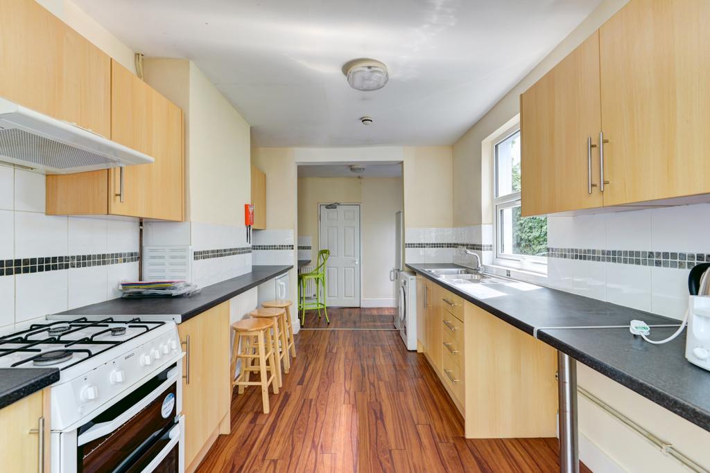 Bright and spacious kitchen with ample storage,...