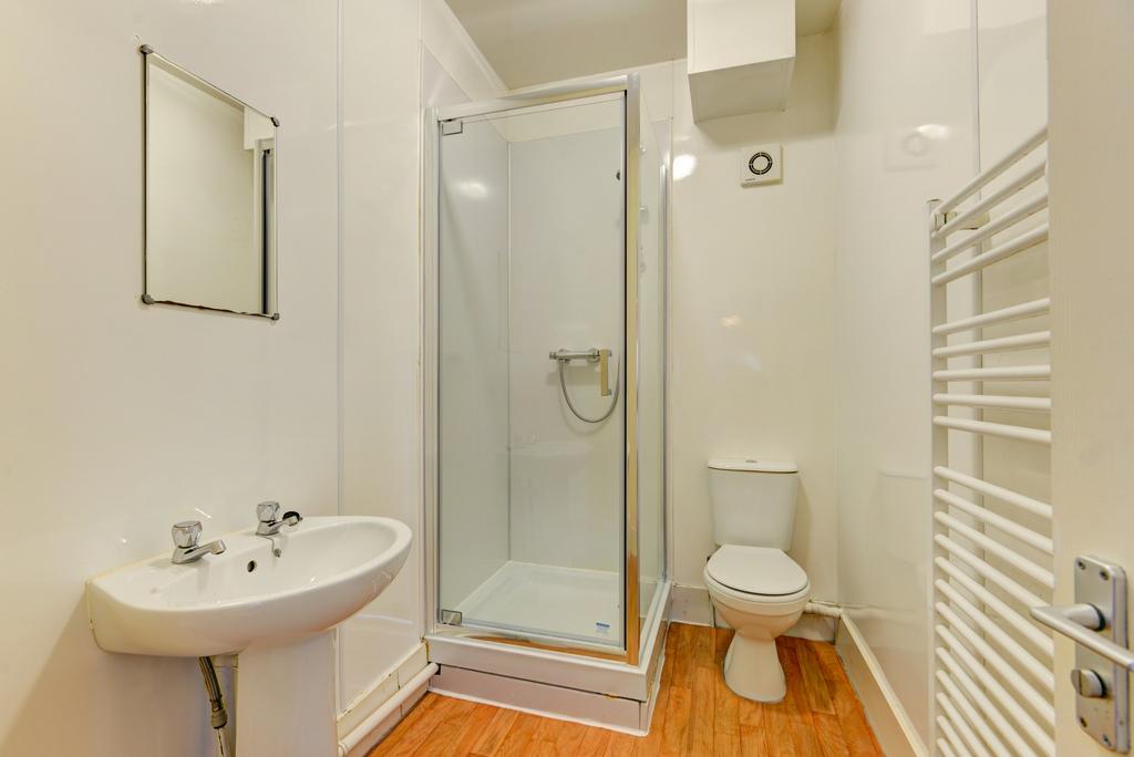 A well-maintained bathroom featuring a shower e...