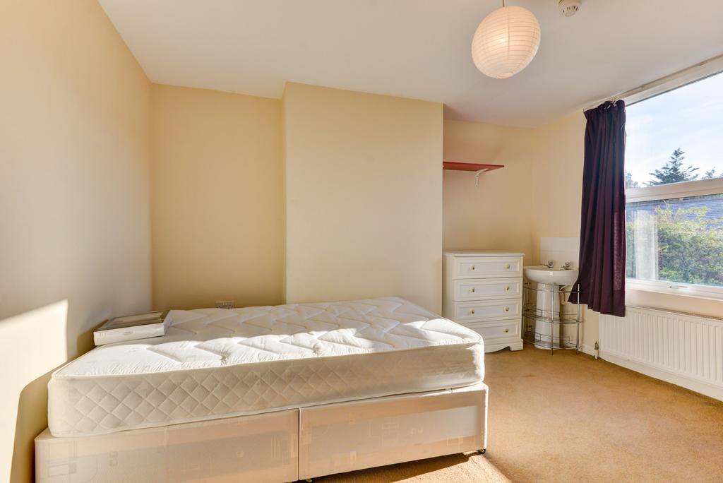 A bright and tidy double bedroom featuring a co...