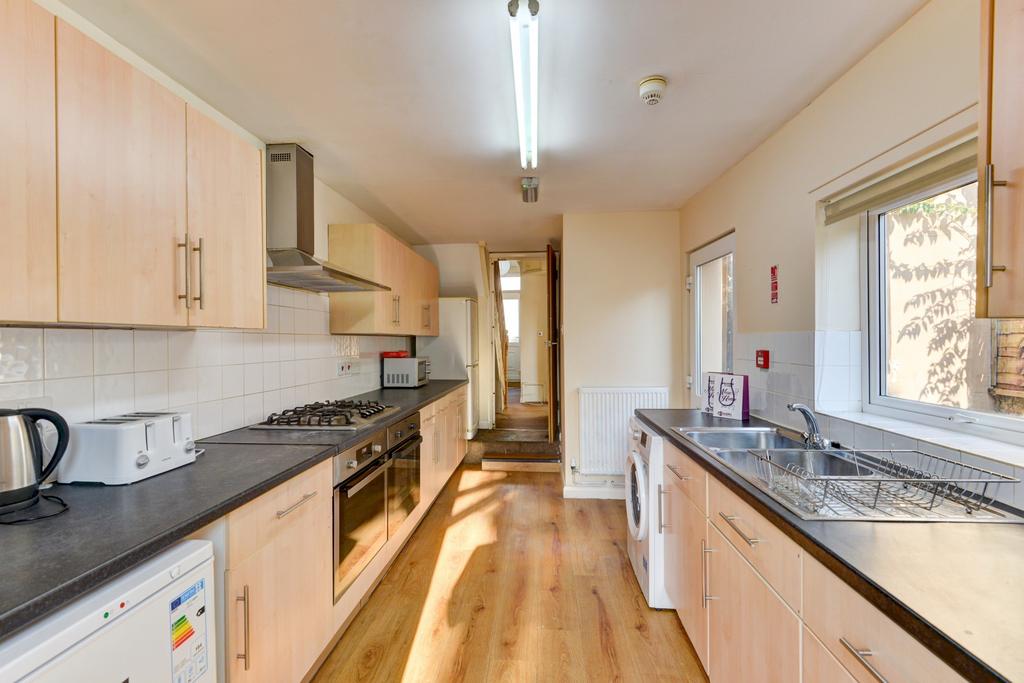 Bright and clean kitchen with ample counter spa...