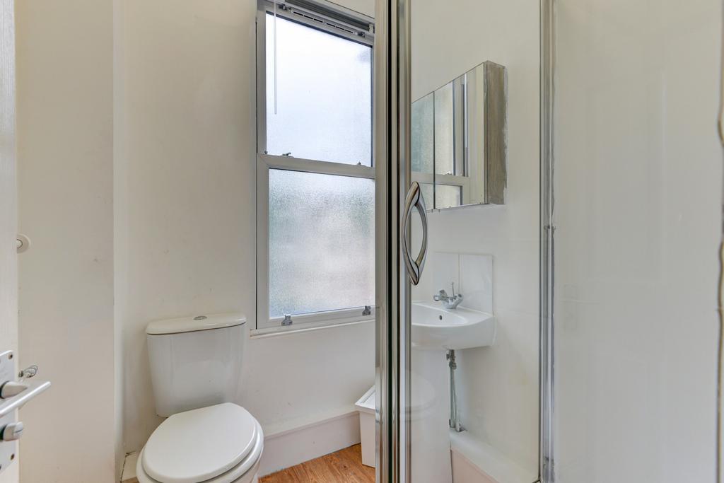 A clean and bright bathroom featuring a toilet,...