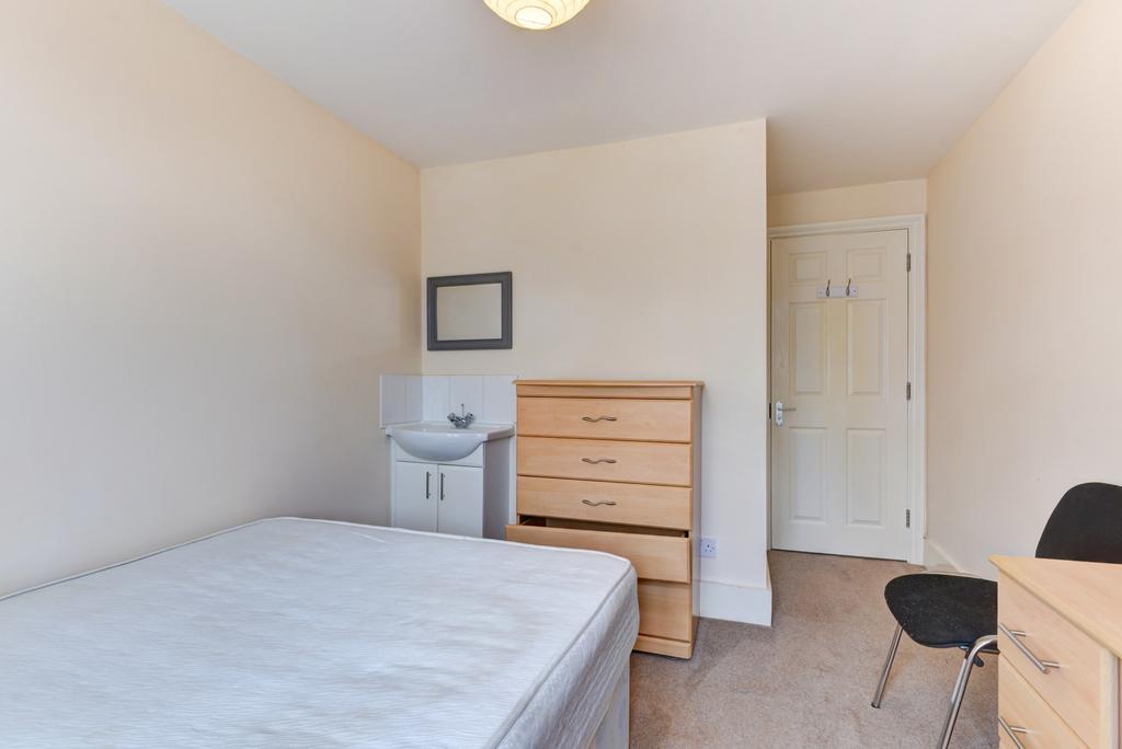 A bright and spacious master bedroom featuring ...
