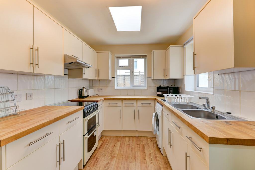 Bright and modern kitchen with ample counter sp...