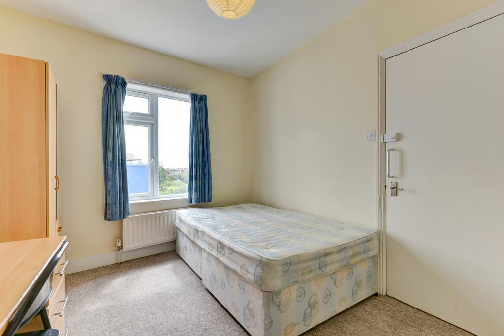 A cozy bedroom featuring a comfortable double b...