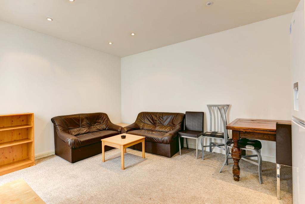 A bright and welcoming living room featuring co...