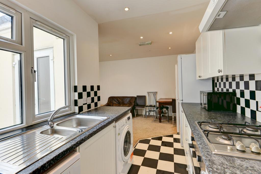 A bright and clean kitchen with a modern checke...